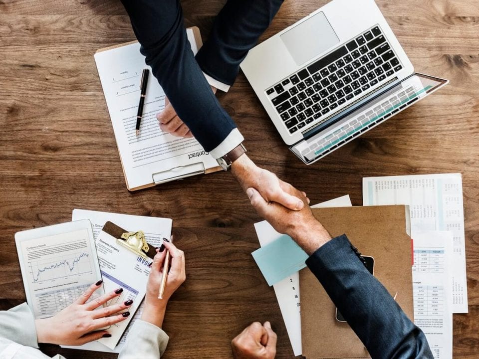 Business People Planning and Shaking Hands